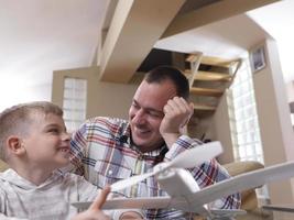 father and son assembling airplane toy photo