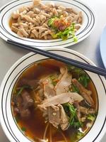 Top view of duck noodles in brown soup and boiled duck intestine. photo