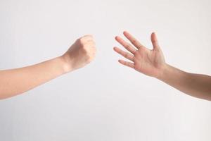 Rock or hammer symbol and paper symbol in playing rock paper scissors game on white background. photo