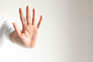 woman gesturing a hand showing five fingers meaning stop and warning to do not do something. photo