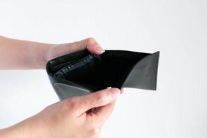 empty wallet in hands on white background. photo