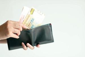 Hands picking Hong Kong money from wallet for paying. photo