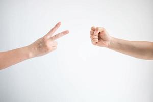 Scissors symbol and hammer symbol in playing rock paper scissors game on white background. photo