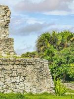 Ancient Tulum ruins Mayan site temple pyramids artifacts seascape Mexico. photo