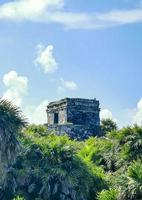 Ancient Tulum ruins Mayan site temple pyramids artifacts seascape Mexico. photo