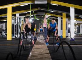 sports couple doing battle ropes cross fitness exercise photo