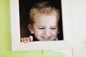 happy child in a window photo