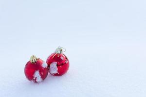 red christmas balls in fresh snow photo