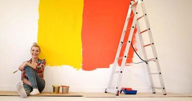 young female painter sitting on floor photo