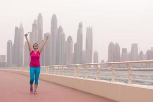 young woman celebrating a successful training run photo