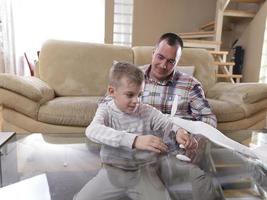 father and son assembling airplane toy photo