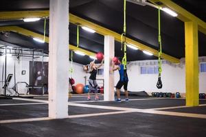 young athletes couple working out with medical ball photo