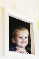 niño feliz en una ventana foto