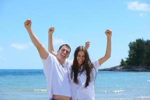 happy couple have fun on the beach photo