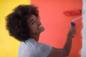 black woman painting wall photo