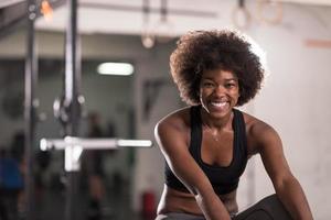 black woman doing sit ups at the gym photo