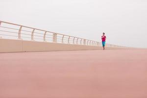 woman busy running on the promenade photo