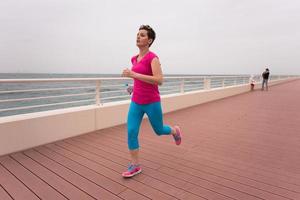 woman busy running on the promenade photo