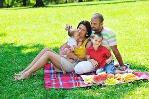 happy young couple with their children have fun at park photo