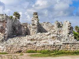 Ancient Tulum ruins Mayan site temple pyramids artifacts seascape Mexico. photo