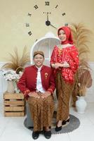 young indonesian moeslim couple with wedding dress photo