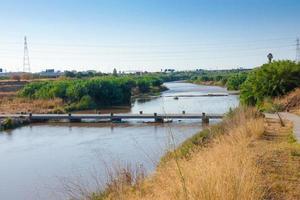 Flood bridge for sportsmen and women crossing the Llobregat river very close to the city of Barcelona. photo