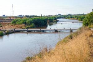 Flood bridge for sportsmen and women crossing the Llobregat river very close to the city of Barcelona. photo