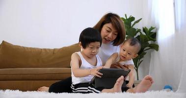 Happy family with mother and kids spending time together at home. photo