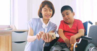 Happy family with mother and disabled son spending time together at home. photo