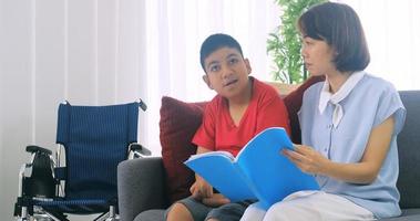 Happy family with mother and disabled son spending time together at home. photo