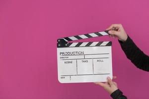 movie clapper on pink background photo