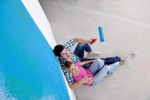 happy young cople relaxing after painting in new home photo