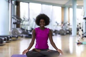african american woman exercise yoga in gym photo