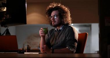 man working on computer in dark office photo