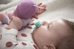 cute little baby playing with hands and smiling photo