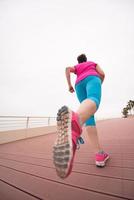 woman busy running on the promenade photo