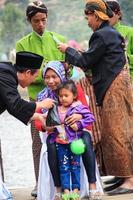 Dieng, Indonesia - August 1, 2015. Dieng Culture Festival, Tourists follow the dreadlocks procession during the Dieng Culture Festival event at Dieng, Banjarnegara district, Central Java photo