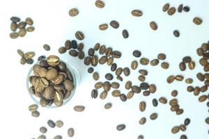 roasted coffee beans in a glass cup isolated on a white background photo