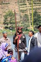 Dieng, Indonesia - August 1, 2015. Dieng Culture Festival, Tourists follow the dreadlocks procession during the Dieng Culture Festival event at Dieng, Banjarnegara district, Central Java photo