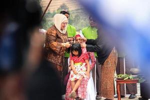 Dieng, Indonesia - August 1, 2015. Dieng Culture Festival, Tourists follow the dreadlocks procession during the Dieng Culture Festival event at Dieng, Banjarnegara district, Central Java photo