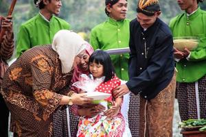 dieng, indonesia - 1 de agosto de 2015. festival cultural de dieng, los turistas siguen la procesión de rastas durante el evento del festival cultural de dieng en dieng, distrito de banjarnegara, java central foto