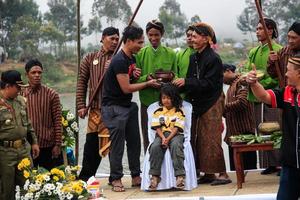 Dieng, Indonesia - August 1, 2015. Dieng Culture Festival, Tourists follow the dreadlocks procession during the Dieng Culture Festival event at Dieng, Banjarnegara district, Central Java photo