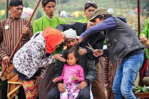 Dieng, Indonesia - August 1, 2015. Dieng Culture Festival, Tourists follow the dreadlocks procession during the Dieng Culture Festival event at Dieng, Banjarnegara district, Central Java photo