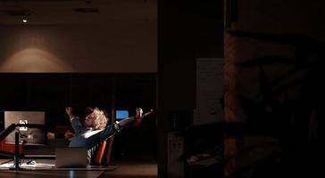 hombre trabajando en una computadora en una oficina oscura foto