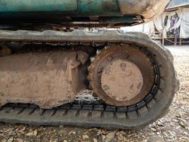 Closeup of the dirty crawler with the dry mud from the paddy field. photo