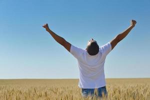 man in wheat field photo