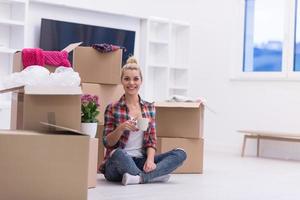 woman with many cardboard boxes sitting on floor photo