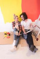 Happy young couple relaxing after painting photo