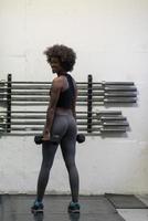 black woman doing bicep curls photo