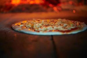 rustic pizza in wood fired oven photo